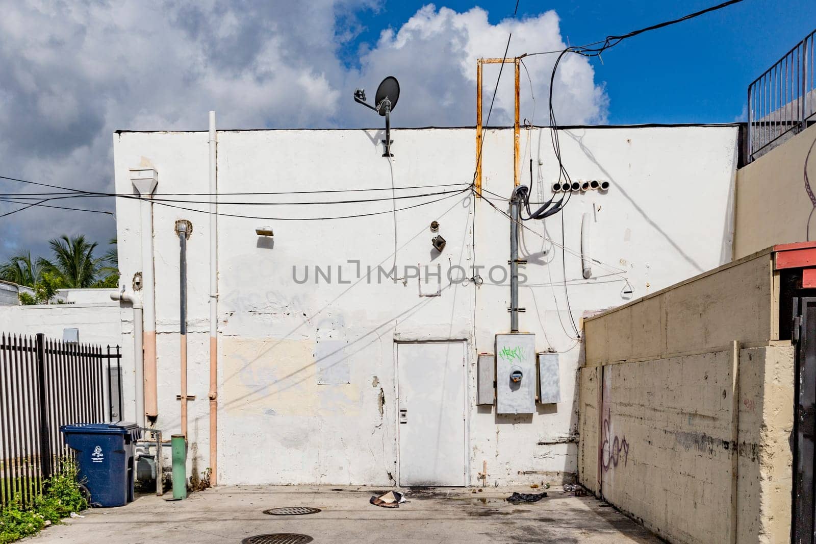 Mimi Beach, USA - August 5, 2013: small street with old buildings in the art deco district with litter box in Miami, USA.