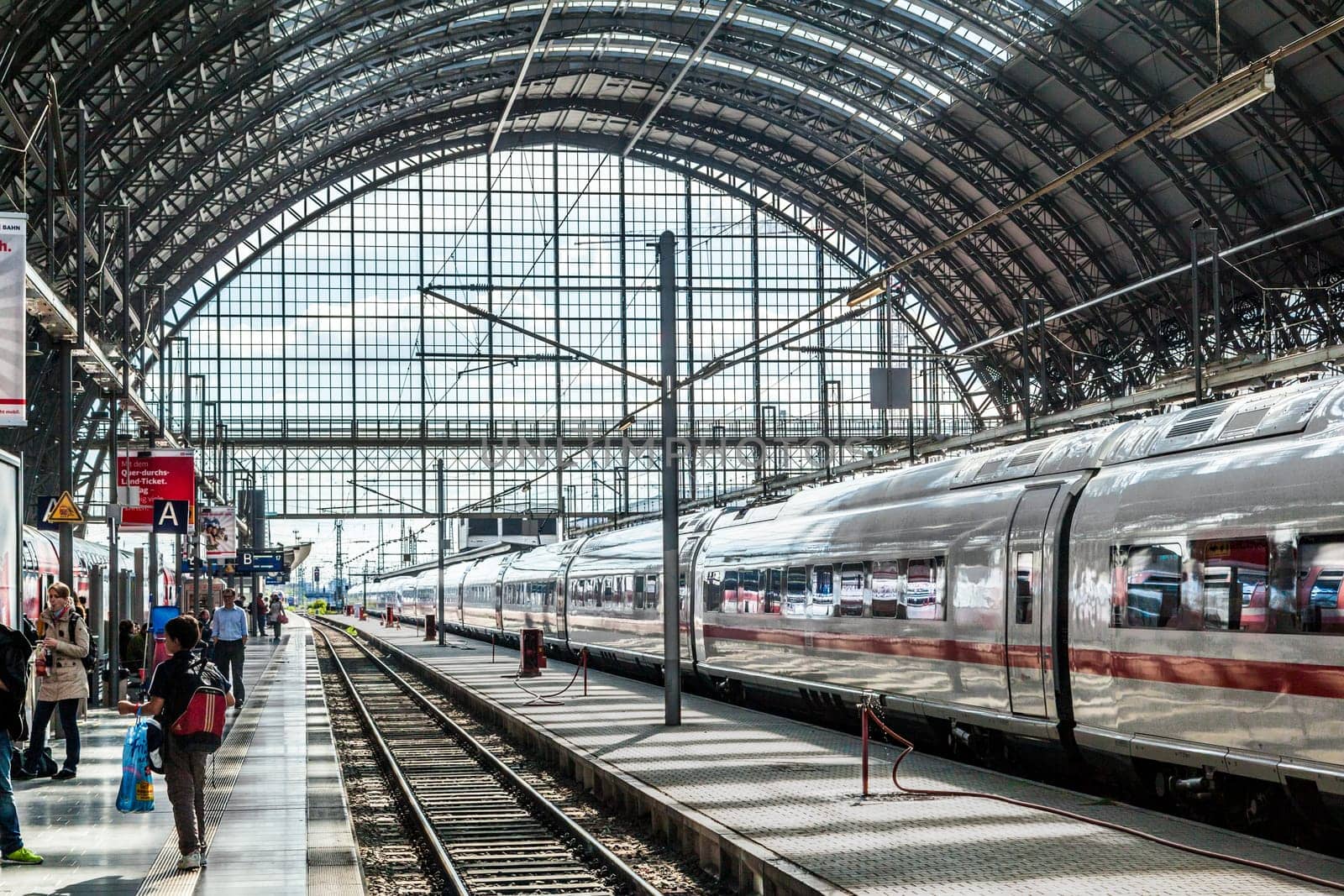 Frankfurt, Germany - May 16, 2014: Inside the Frankfurt central station in Frankfurt, Germany. People hurry to the intercity high speed train.