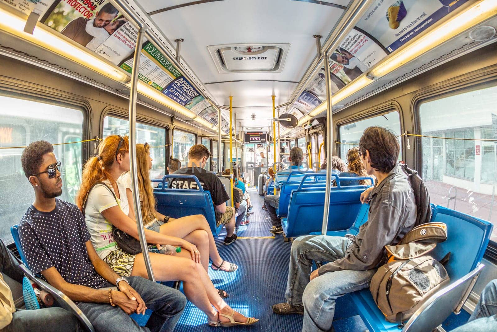 MIAMI, USA - AUG 18, 2014: people in the downtown Metro bus in Miami, USA. Metrobus operates more than 90 routes with close to 1,000 buses covering 41 million miles per year.