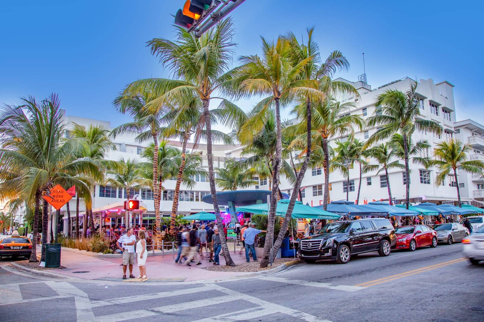 Miami, USA - August 23, 2014: Palm trees and art deco hotels at Ocean Drive by night. The road is the main thoroughfare through South Beach in Miami, USA.