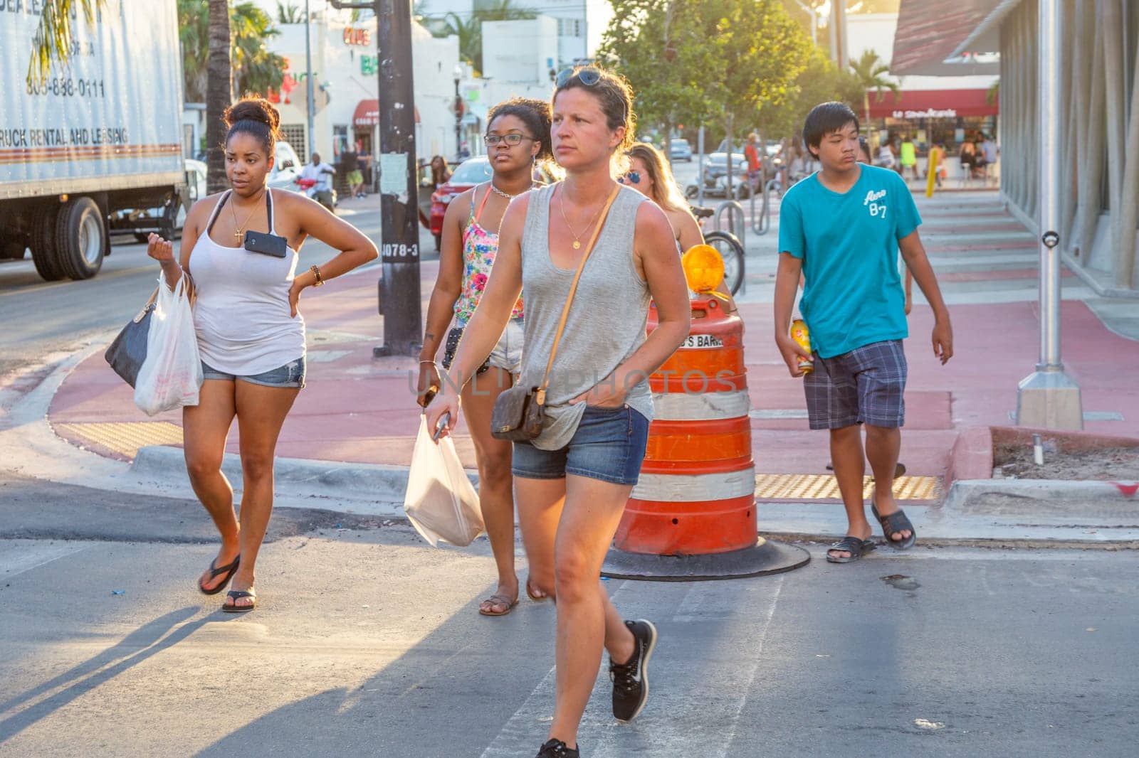 Miami, USA - August 23, 2014: tourists  in the art deco district in South Beach, Miami, USA crossing a road.