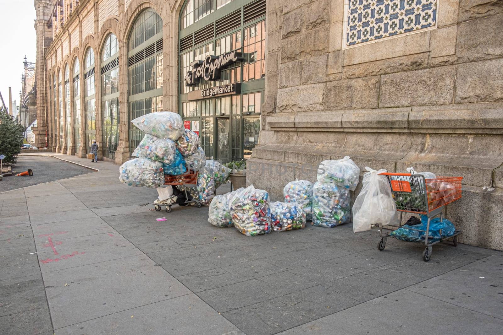 New York, USA - October 4, 2017: poor people collect cans and plastic bottles and sell them back to shops. They earn money by getting a small deposit on the cans.