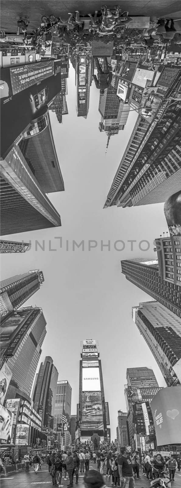 NEW YORK, USA - OCT 4, 2017:  people visit times square with neon advertising of News, brands and theaters   in late afternoon. Times square is a symbol for New York life and amusement.