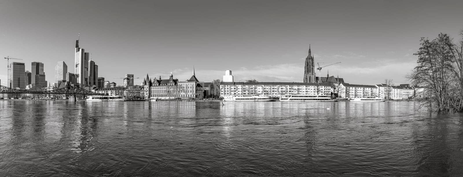 Frankfurt, Germany - January 9, 2018: panoramic view to skyline of Frankfurt am Main, Germany with high water at river Main.
