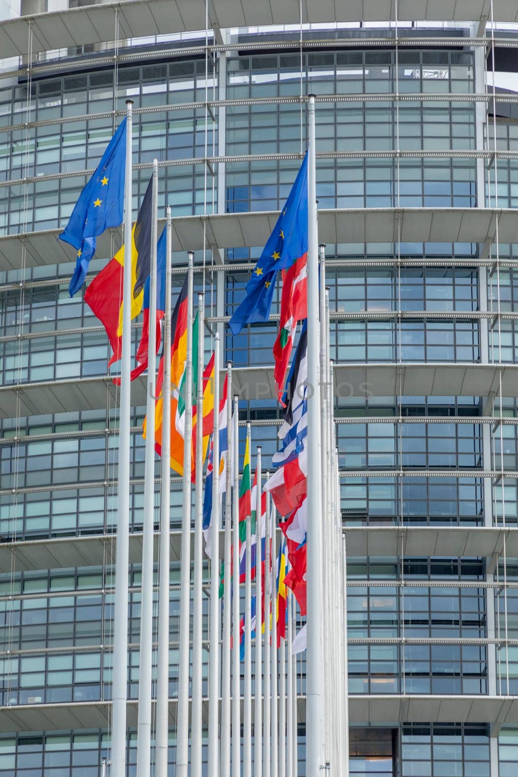 STRASBOURG, FRANCE - JUNE 18, 2018: All EU Flags European Union flag waving in front of European Parliament, headquarter of the European Commission European Parliament