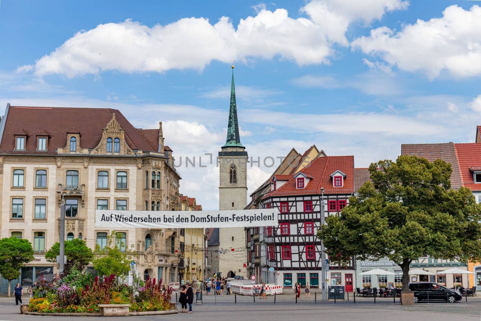 Erfurt, Germany - July 29, 2018: people at the dome square with banner Auf Wiedersehen bei den Domstufen Festspielen - engl: see again at next cathedral Festival.