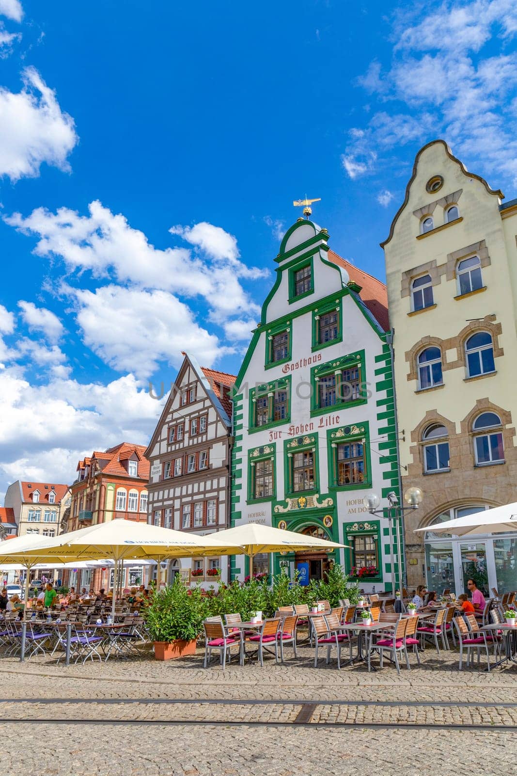 Erfurt, Germany - July 29, 2018: people at the central square in front of the cathedral at the city of Erfurt, Germany. Erfurt is the Capital of Thuringia and the city was first mentioned in 742.