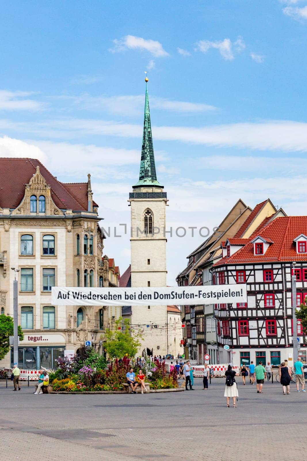 Erfurt, Germany - July 29, 2018: people at the dome square with banner Auf Wiedersehen bei den Domstufen Festspielen - engl: see again at next cathedral Festival.