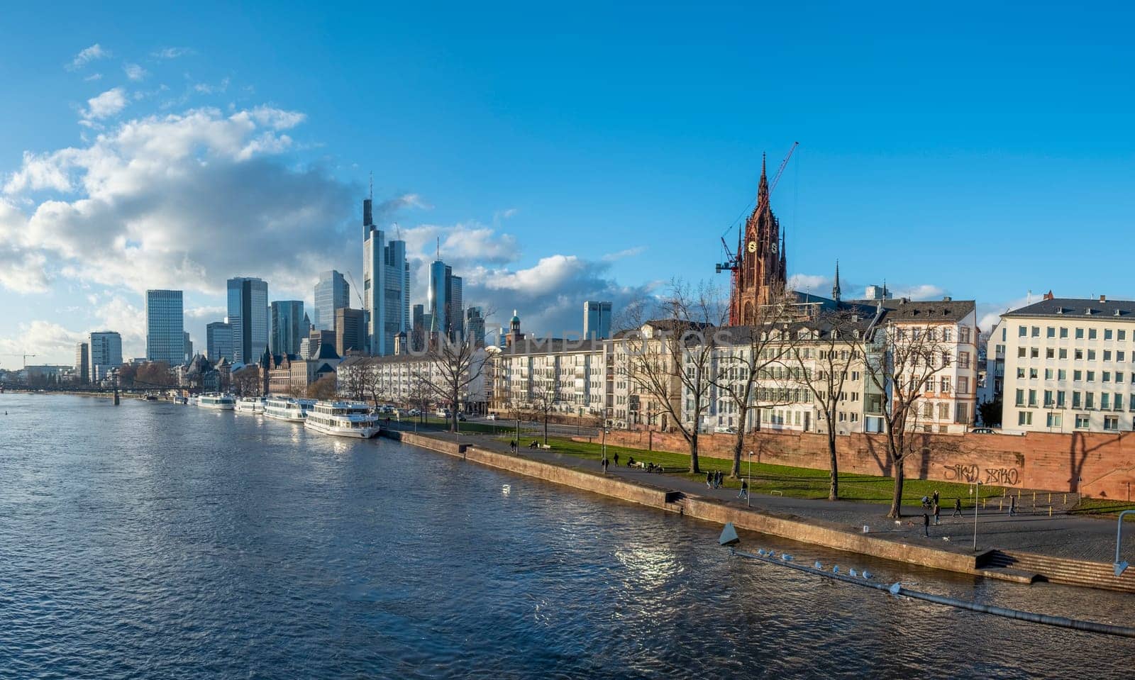 Frankfurt, Germany - January 14, 2019: skyline of Frankfurt am Main with ships on river Main.