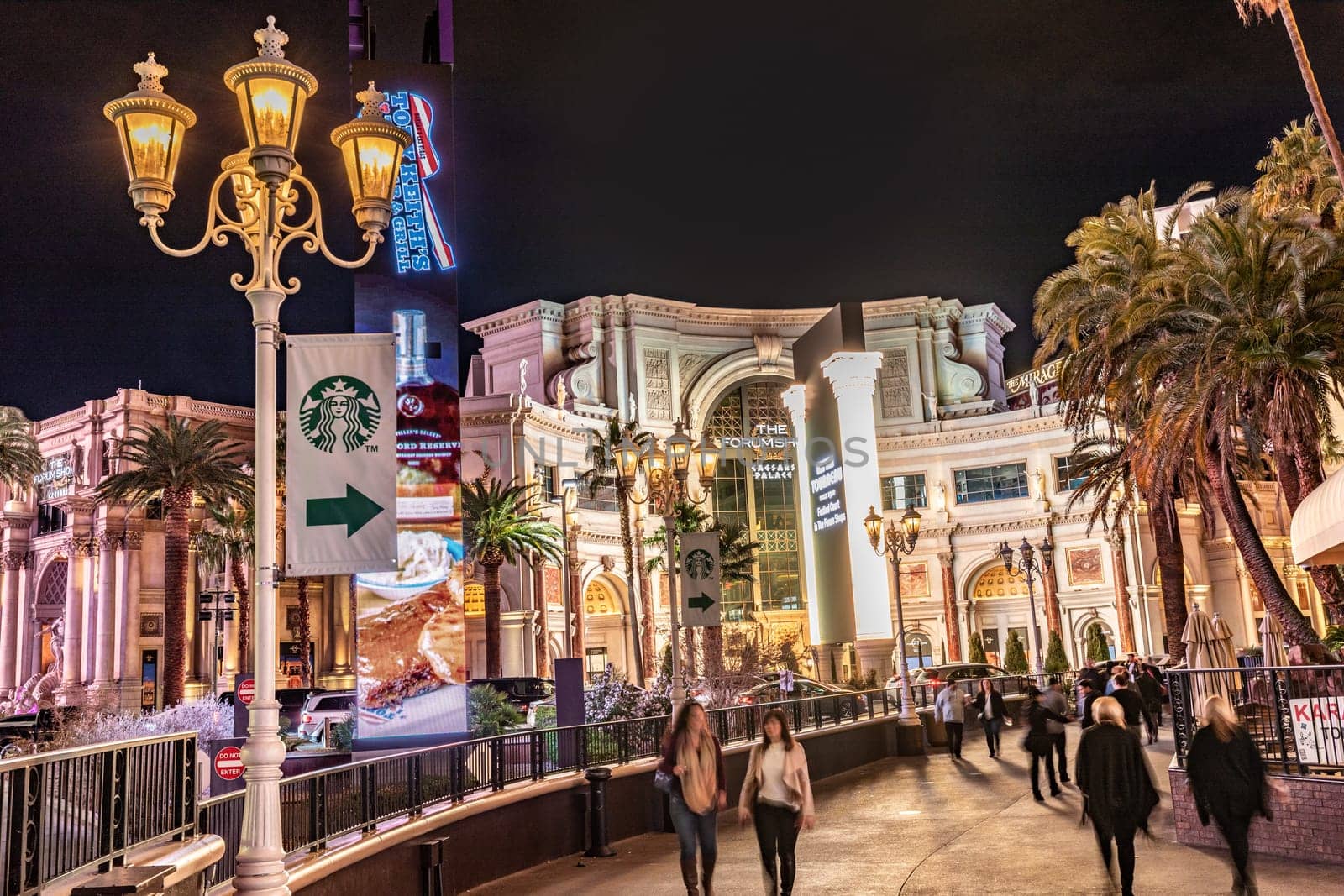 Las Vegas,  USA - March 3, 2019: Neon lights at the shoppingt mall the Forum and Hotel and Casino at the Las Vegas Strip at nigh.