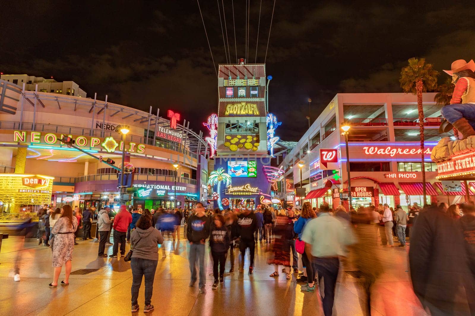 Las Vegas, USA - March 9, 2019: Fremont Street with many neon lights and tourists in downtown Las Vegas. It was the first paved street in Las Vegas in 1925.