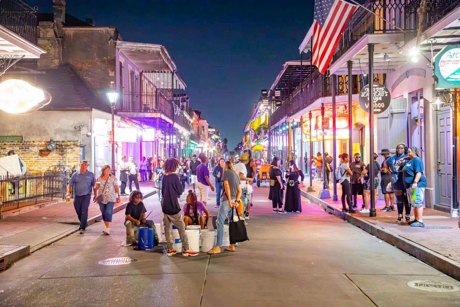 New Orleans  USA - October 24, 2023: people visit Pubs and bars with neon lights in the French Quarter, downtown New Orleans.