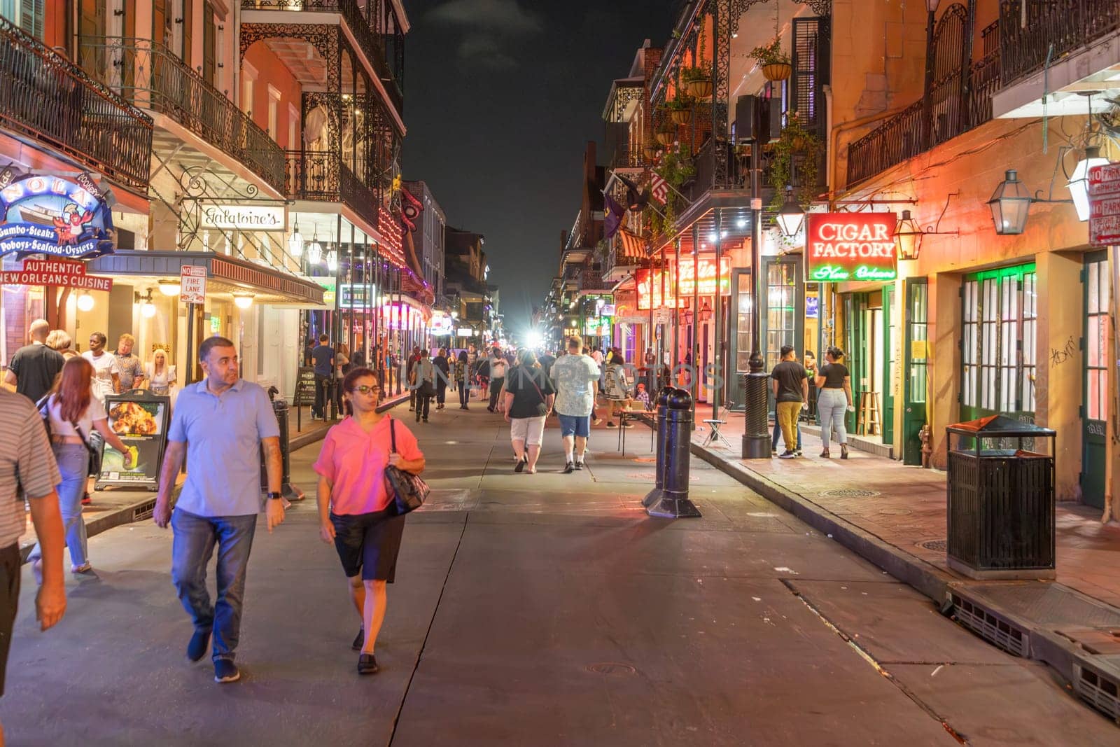 New Orleans  USA - October 24, 2023: people visit Pubs and bars with neon lights in the French Quarter, downtown New Orleans.