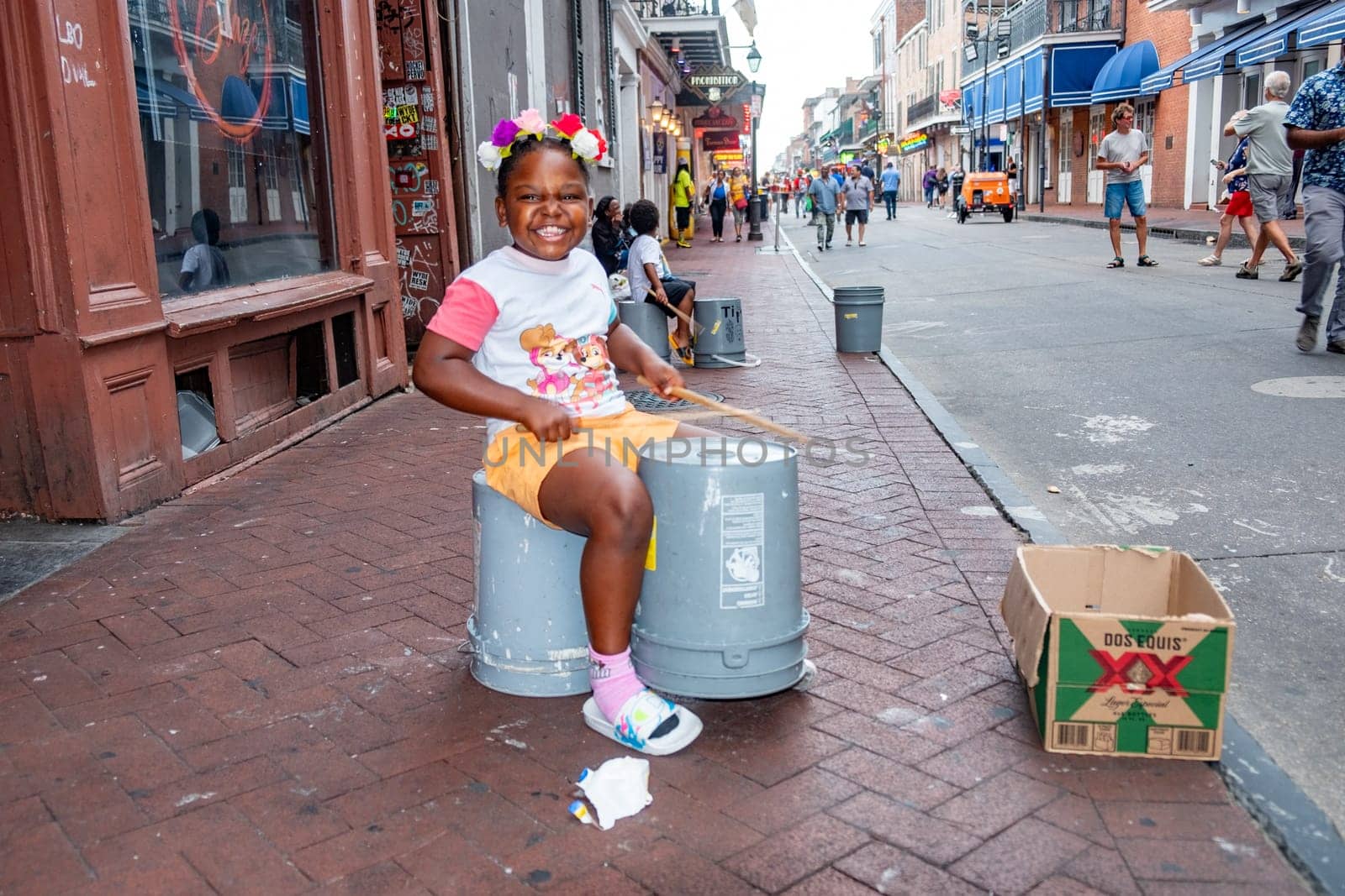 New Orleans  USA - October 24, 2023: young girl plays drums on plastik bins at French Quarter, downtown New Orleans.