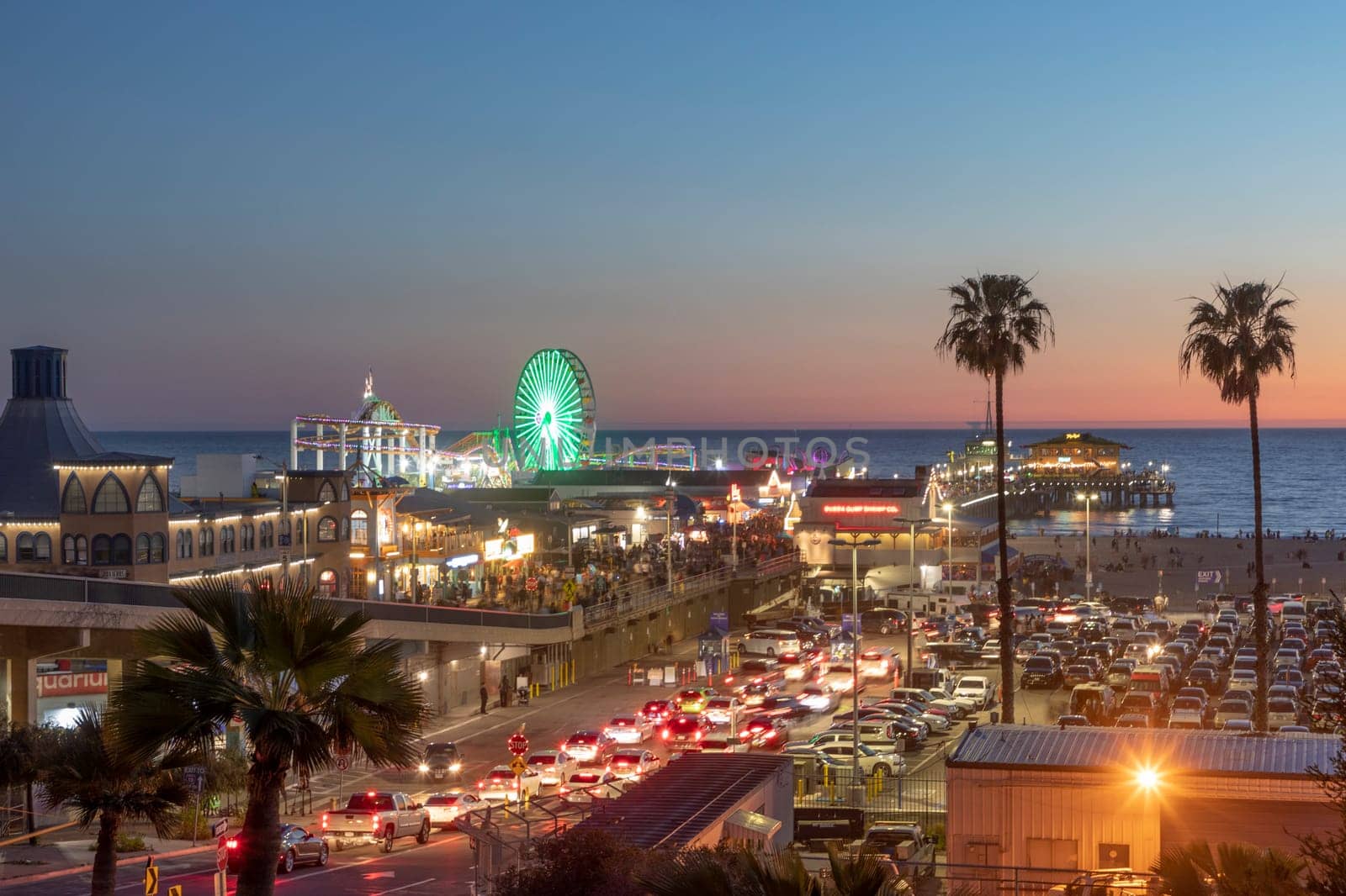 SANTA MONICA, USA - MAR 17, 2019: The  Santa Monica Pier in Santa Monica, USA by night. The site is an iconic 100-year-old landmark for California visitors.