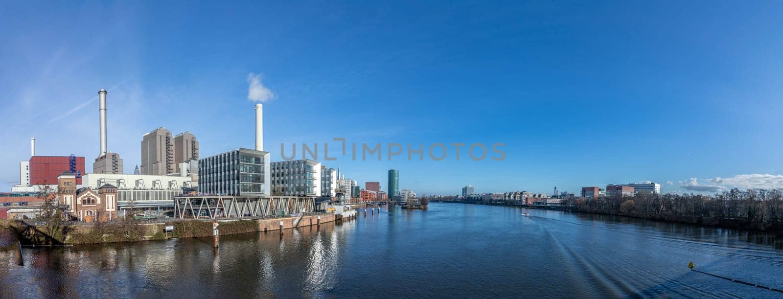 Frankfurt, Germany - Jan 11, 2020: view to coal fired power plant and historic pressurized water works at west harbor area in Frankfurt, Germany.