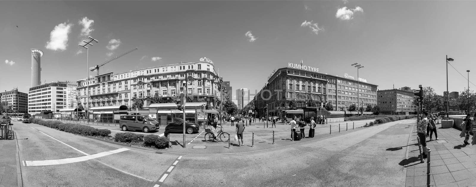 Frankfurt, Germany - June 21, 2021: people at the square in front of the central station with view to skyscraper.