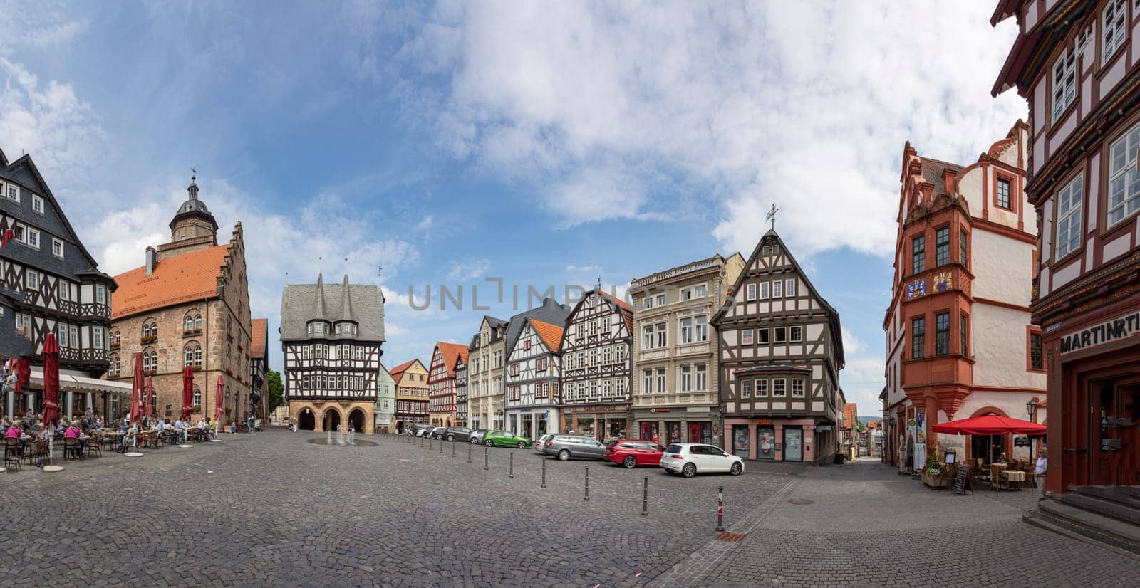 Alsfeld, Germany - June 25, 2021: famous town hall and half timbered historic houses at central square in Alsfeld, germany.