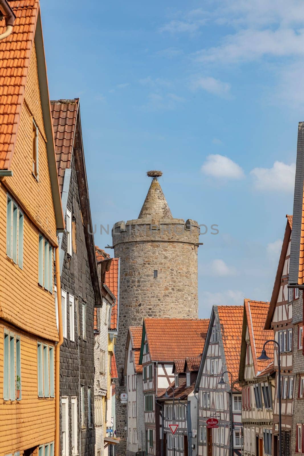 Alsfeld, Germany - June 25, 2021: famous town hall and half timbered historic houses at central square in Alsfeld, germany.