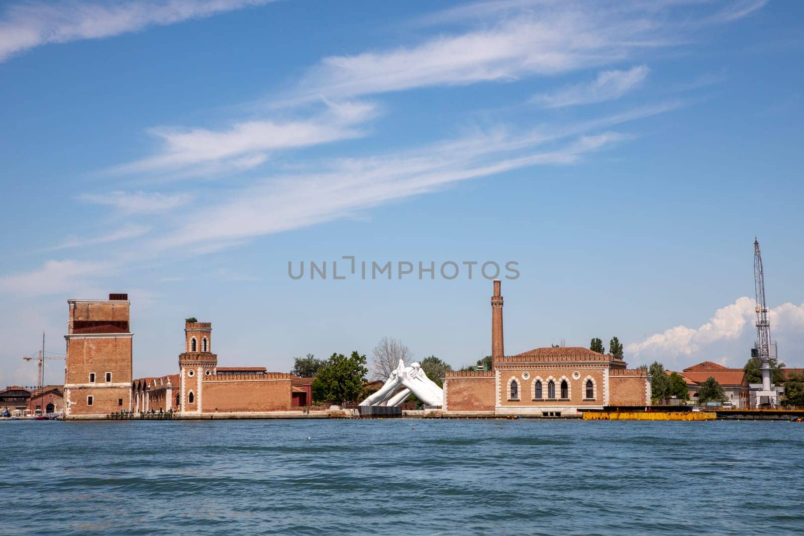Venice, Italy - July 1, 2021: Lorenzo Quinn's Giant Stone Hands Represent Humanity’s Universal Values At Venice Art Biennale in Venice, Italy.