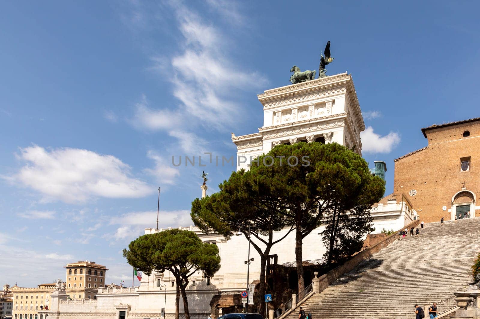Rome, Italy - August 1, 2021: people visit the forum romanum in Rome with famous altare di patria, engl: altar of the home country.