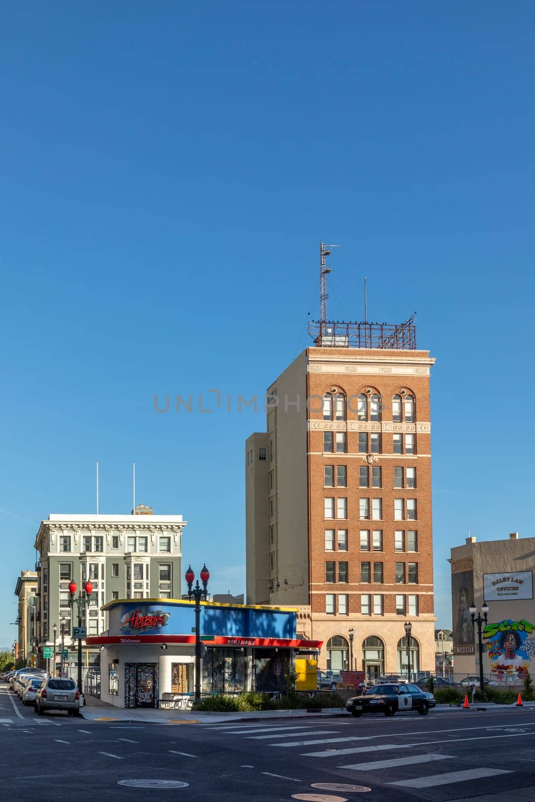 Oakland, USA - May 19, 2022: The morning sun rises at the 17th street with old ihistoric skyscraper and warehouse buildings in Downtown Oakland.