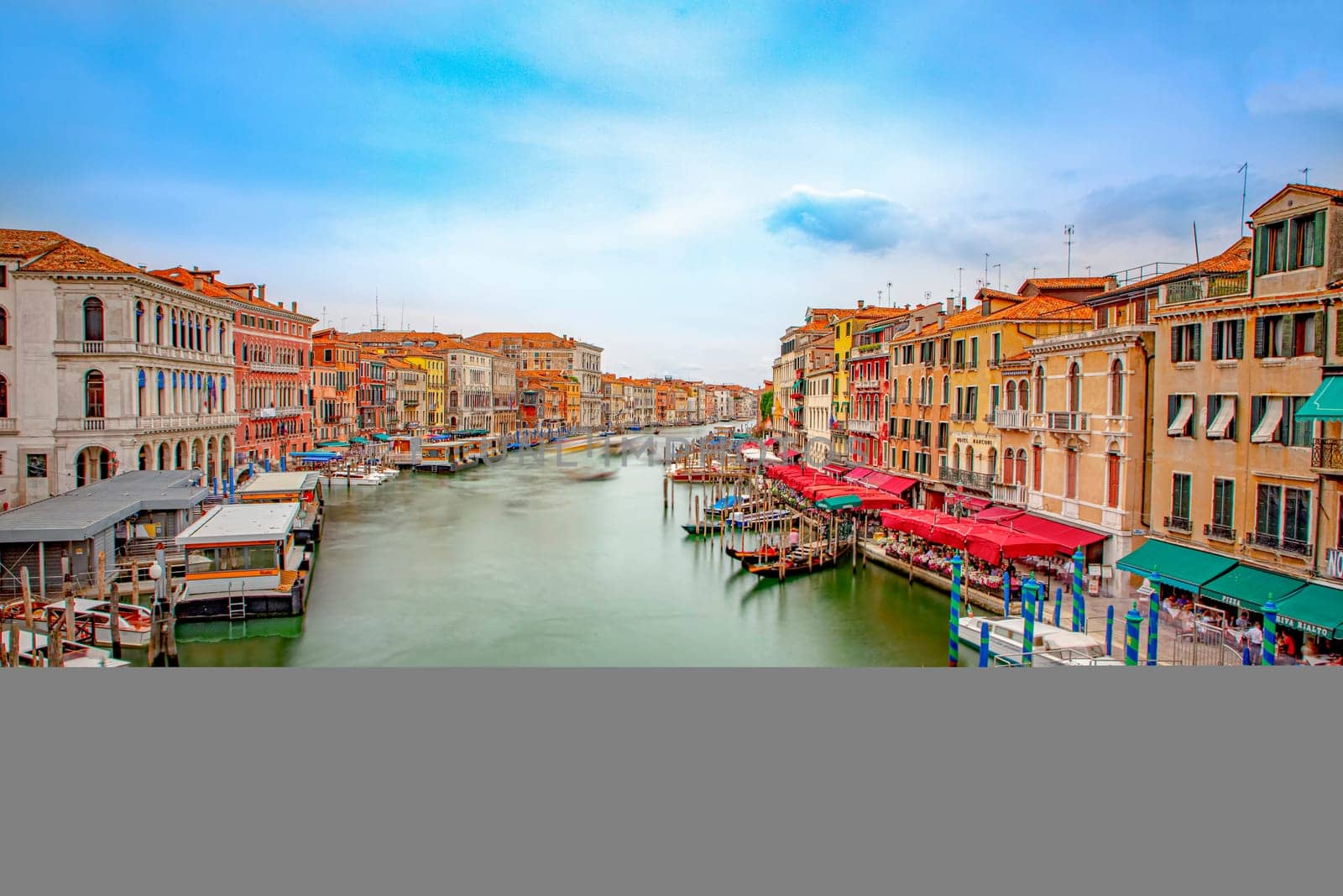 Venice, Italy - July 4, 2021: view from Rialto bridge to canale grande in Venice with ships in motion, Italy.