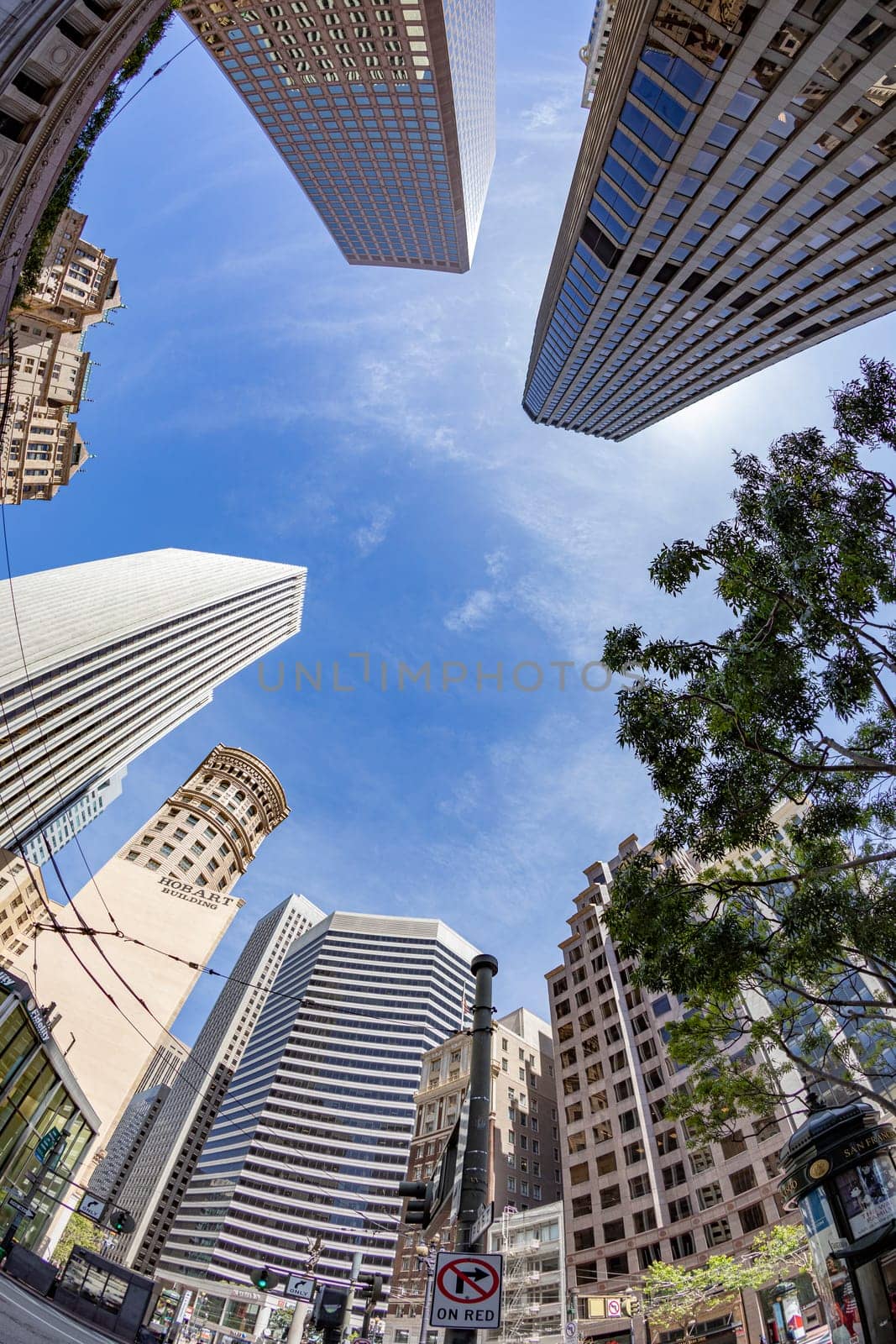 San Francisco, USA - May 19, 2022: modern skyscraper standind near historic buildings land skyscraper in San Francisco seen from Market street.