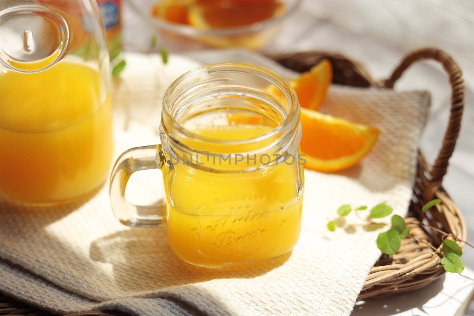 Orange juice poured into a mason jar mug cup