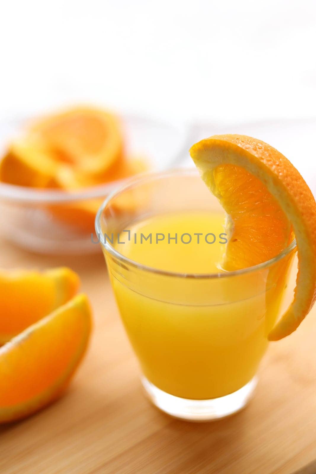 Fresh oranges and a glass of orange juice