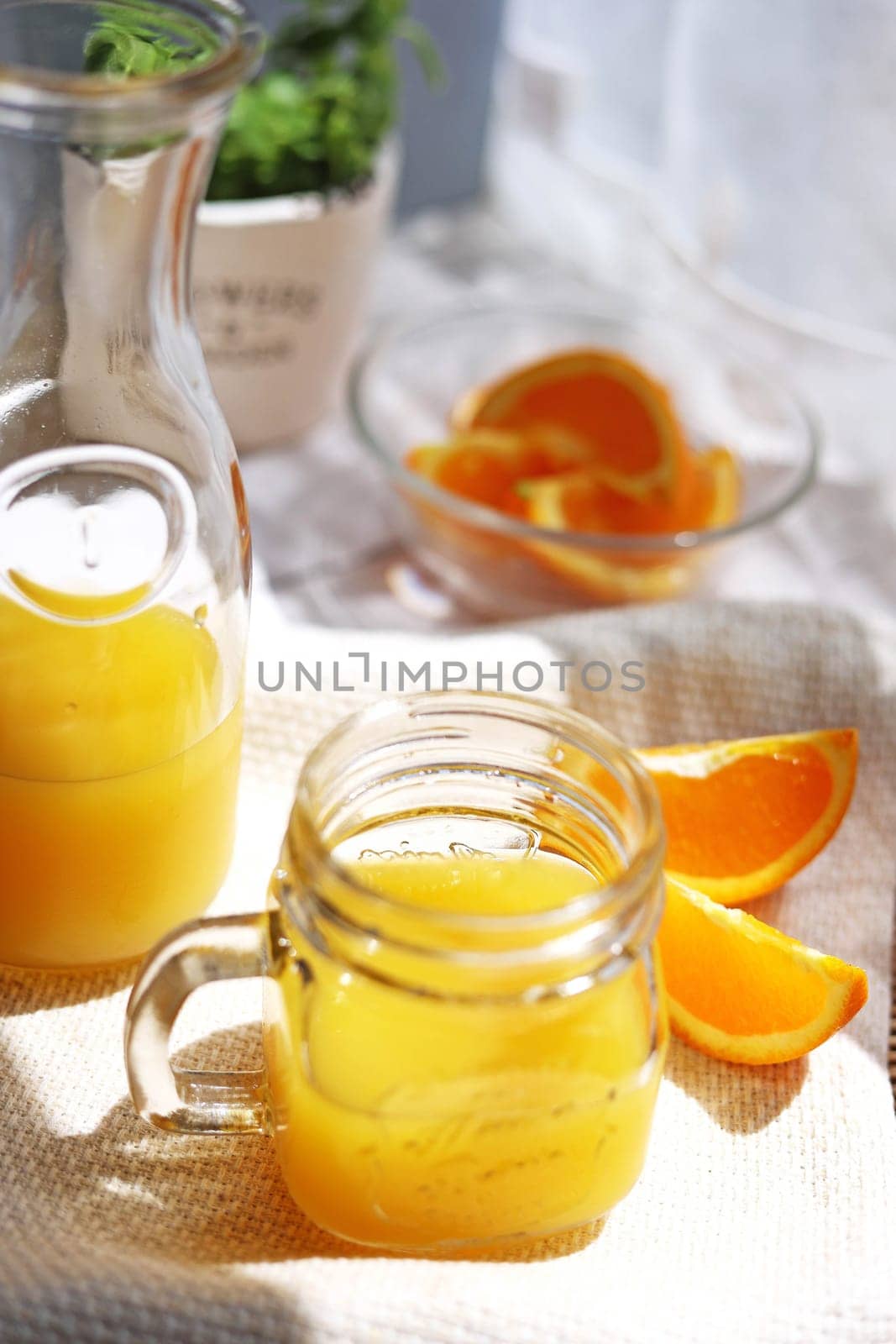 Orange juice poured into a mason jar mug cup