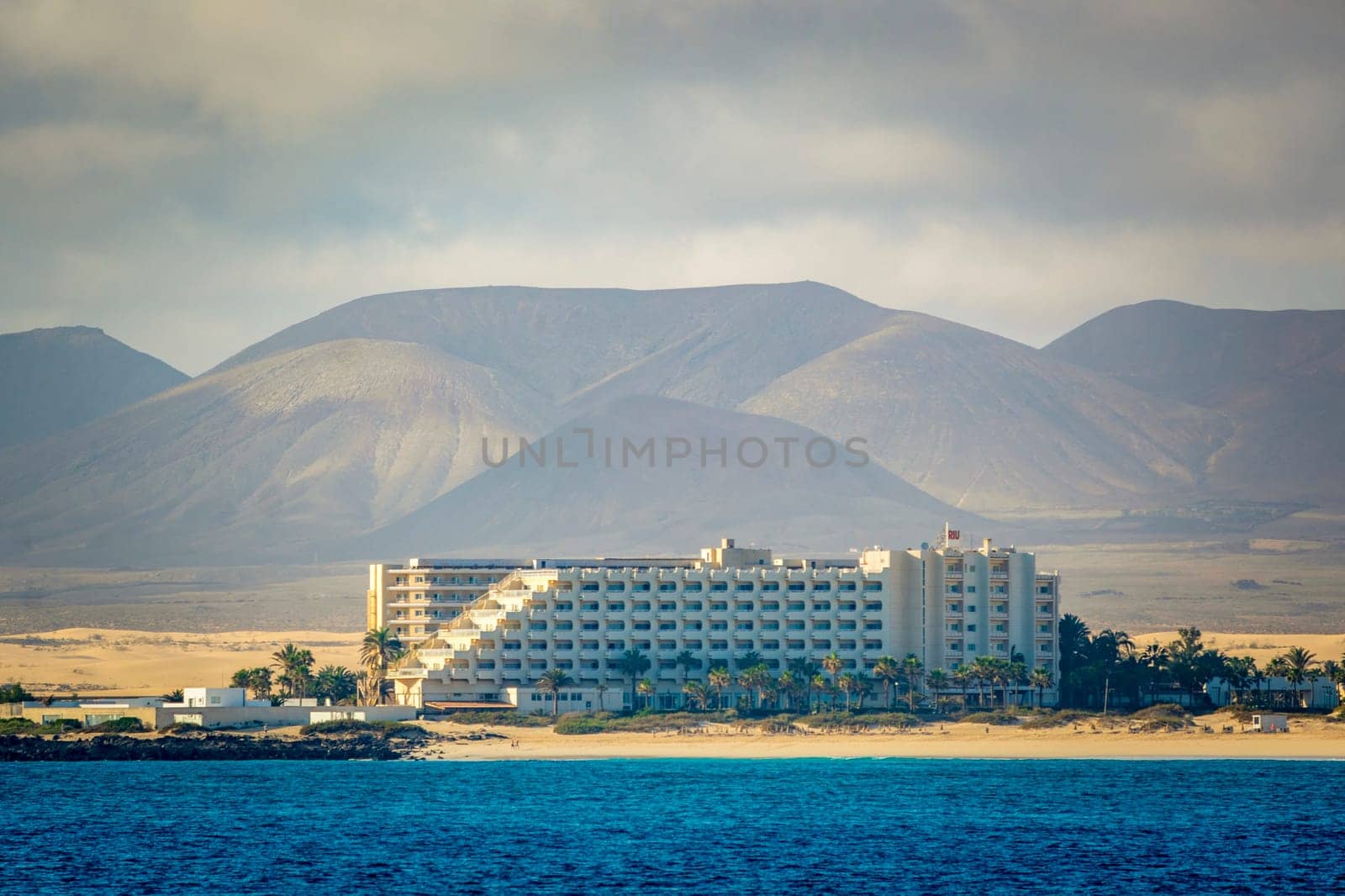 Corralejo, Spain, February 16th 2024: View on the sand dunes of Fuerteventura with Hotel Riu Palace Tres Islas