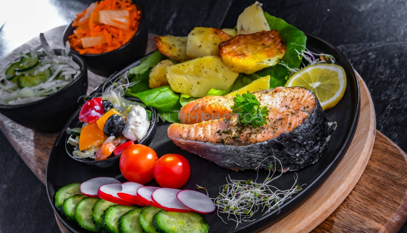 Fried salmon with potatoes and vegetable salads