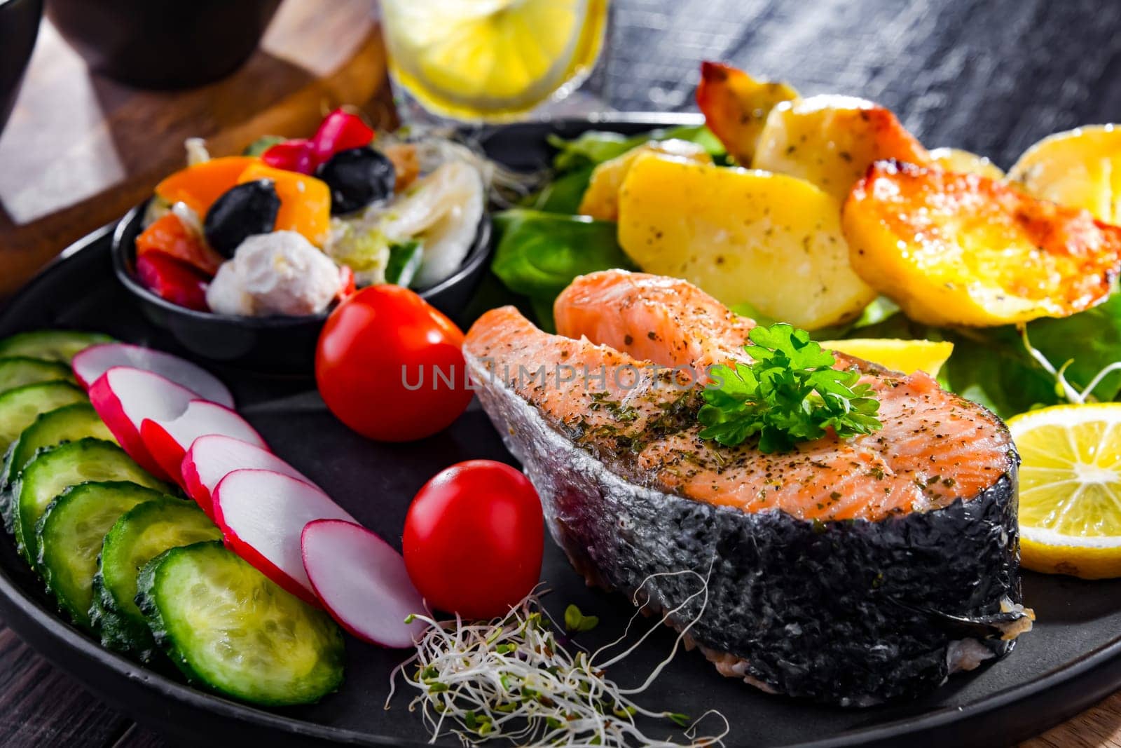 Fried salmon with potatoes and vegetable salads