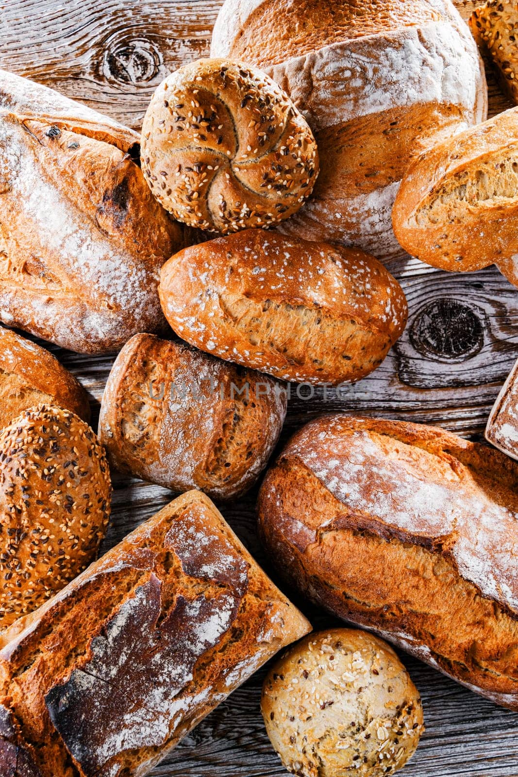 Composition with assorted bakery products on wooden table.