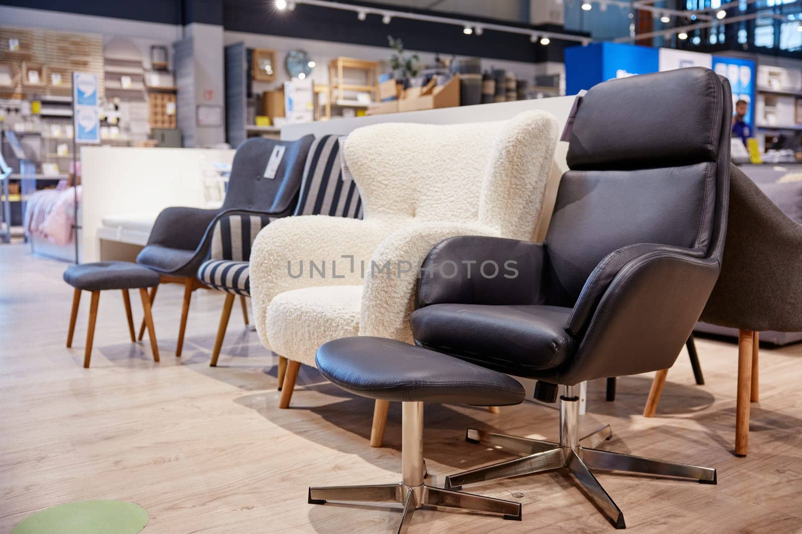 Furniture shop store assortment of modern soft armchair and poof. Comfortable furniture for home renovation of design interior