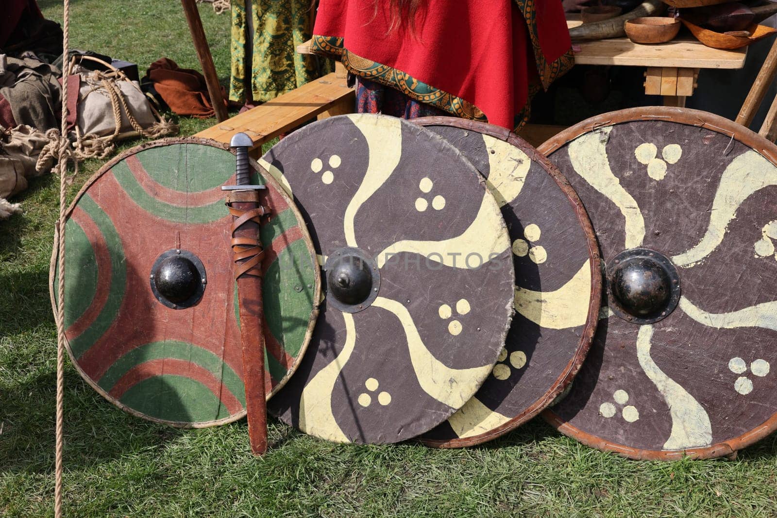 Medieval weapons, shields in knight camp at the festival of historical reconstruction