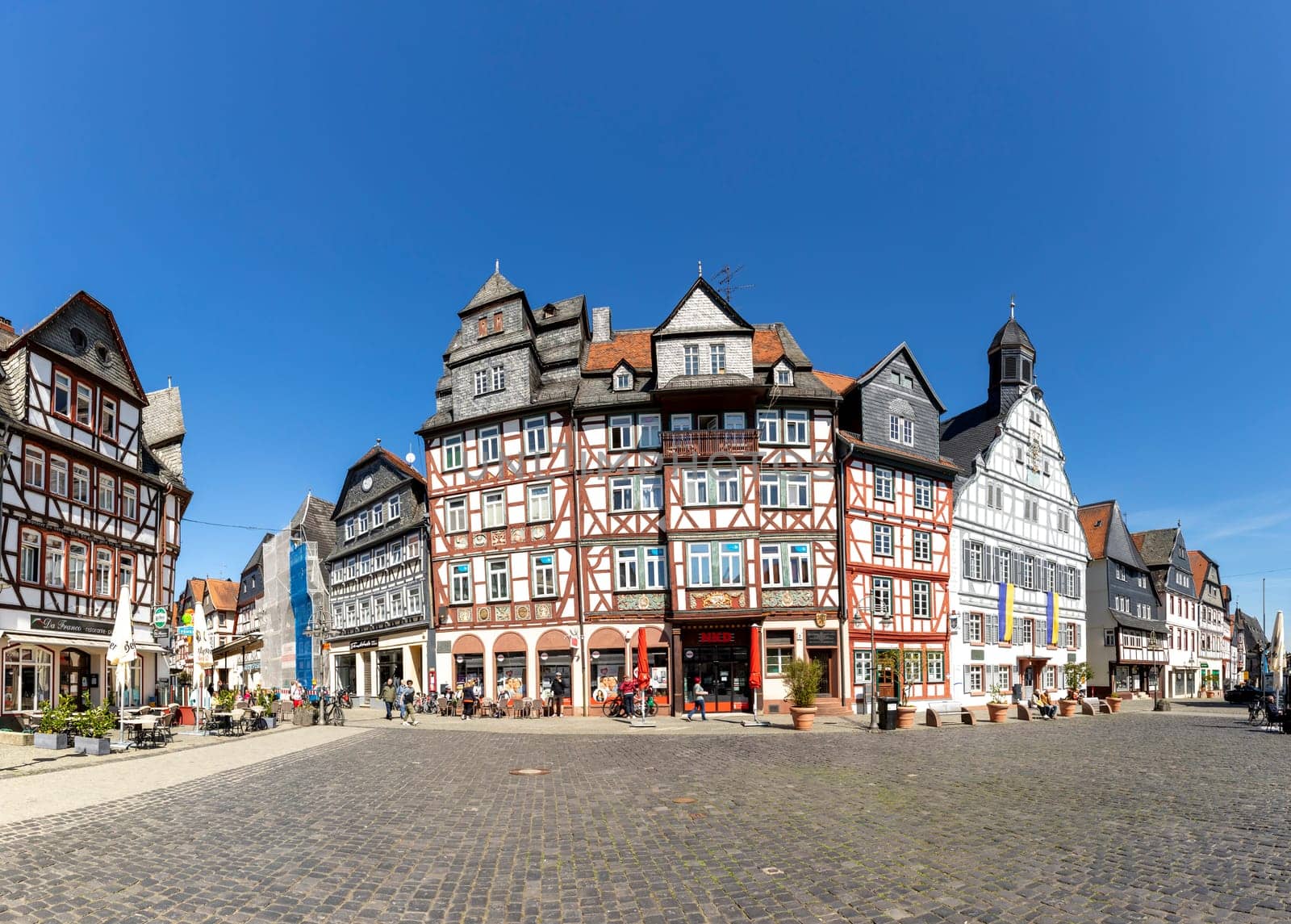 Butzbach, Germany - April 18, 2022: people at the market square in the old town of butzbach germany