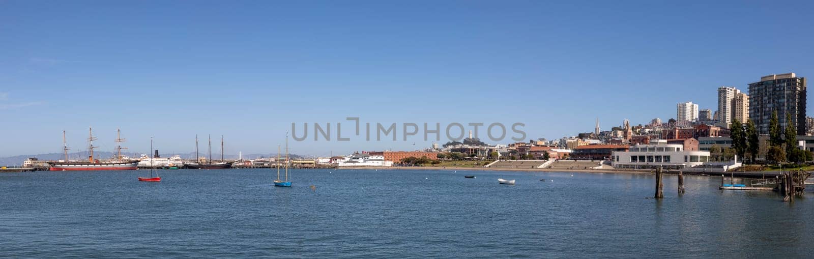 San Francisco, USA - May 18, 2022: panoramic view to fishermans wharf area in San Francisco with skyline and old traditional boats at Hyde street pier.
