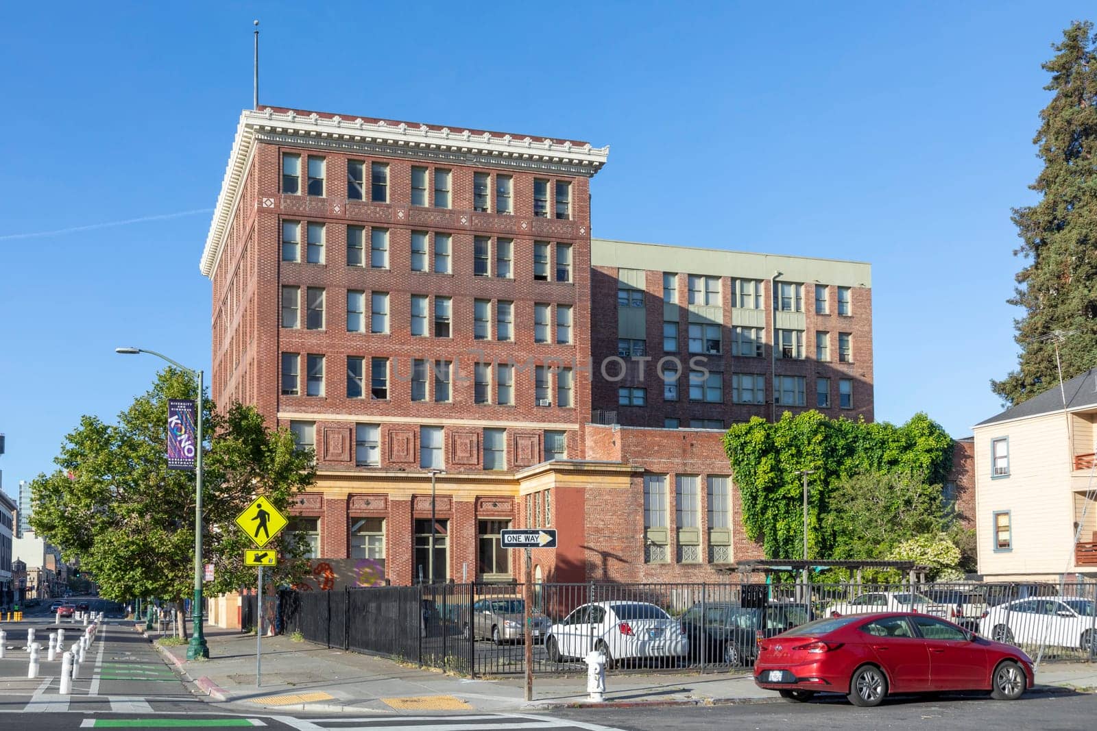 Oakland, USA - May 19, 2022: The morning sun rises on the iconic old brick building in Downtown Oakland.