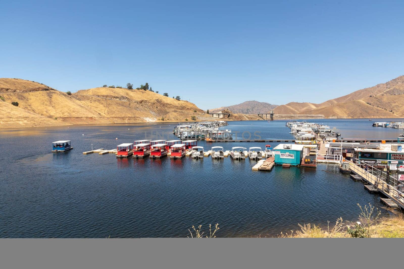 Three Rivers, USA - May 21, 2022: house boats at the pier in Lake Kaweah are for rent for tourists.