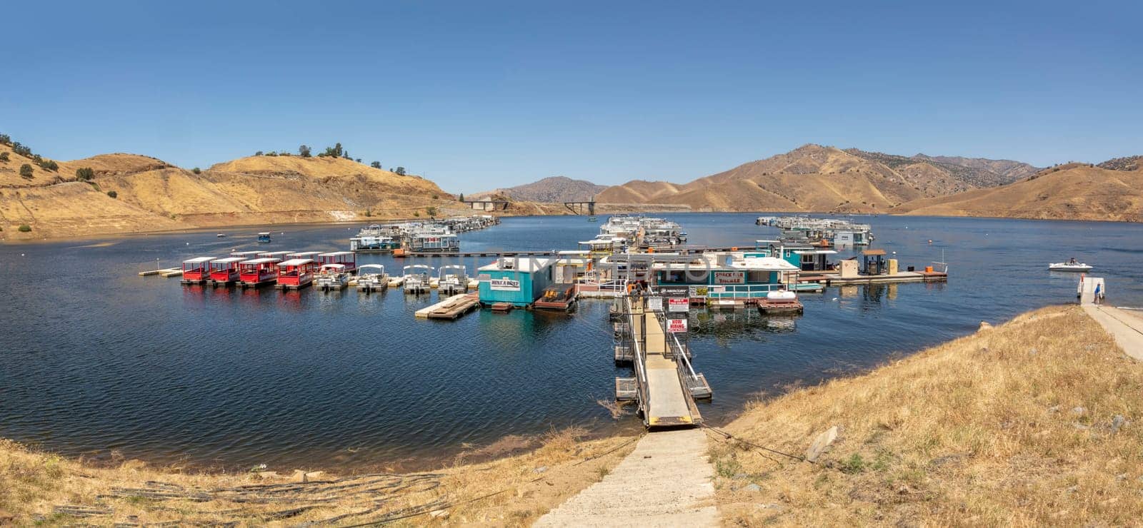 Three Rivers, USA - May 21, 2022: house boats at the pier in Lake Kaweah are for rent for tourists.
