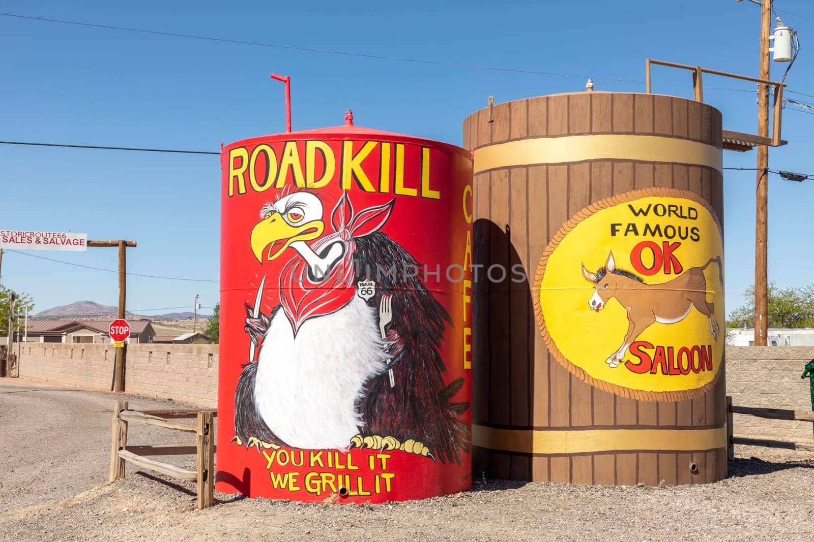 Seligman, USA - May 25, 2022: advertising for Roadkill cafe with slogan you kill it we grill it and Saloon at route 66 at a huge water tank in Seligman, Route 66.