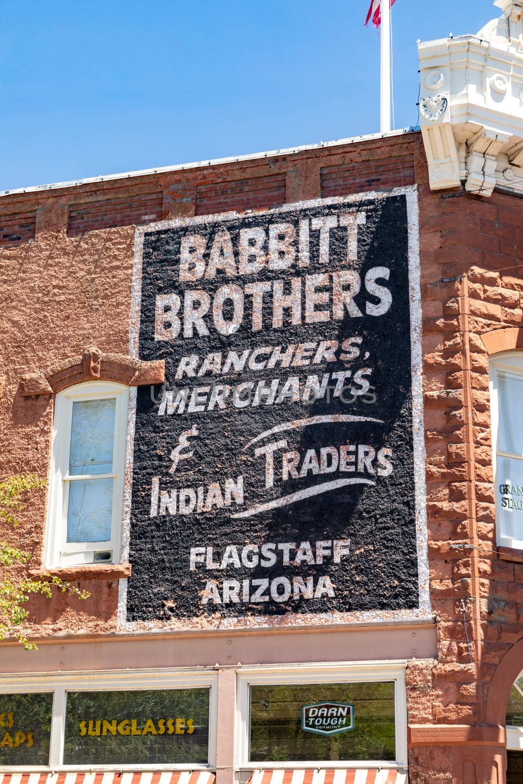Flagstaff, USA - May 26, 2022: old historic brick building with advertising downtown Flagstaff.