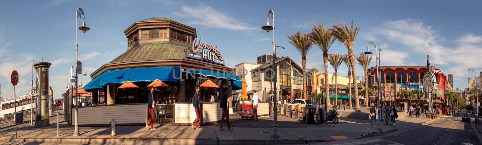San Francisco, USA - June 7, 2022:  people enjoy eating and looking at fishermans wharf in San Francisco on a sunny afternoon.