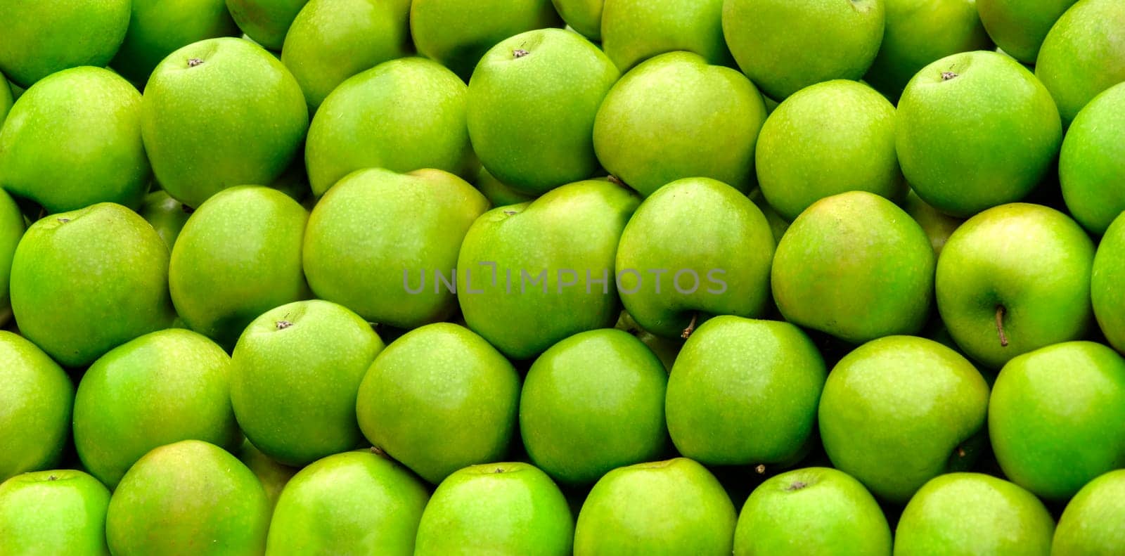 Tasty organic green apples assortment from bio farm. Summer fruit texture background. Healthy food pattern design.
