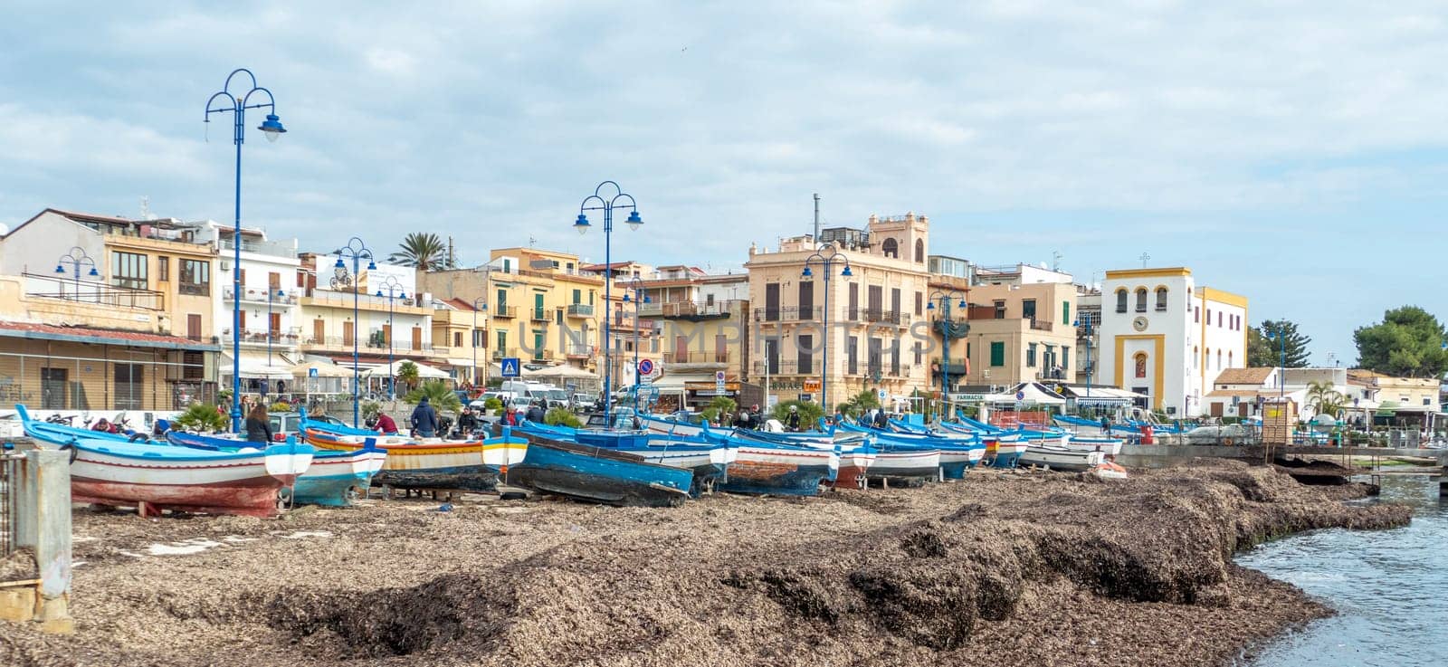 Modello, Italy - February 11, 2023: fishermens boats at the beach  in the center of Mondello.