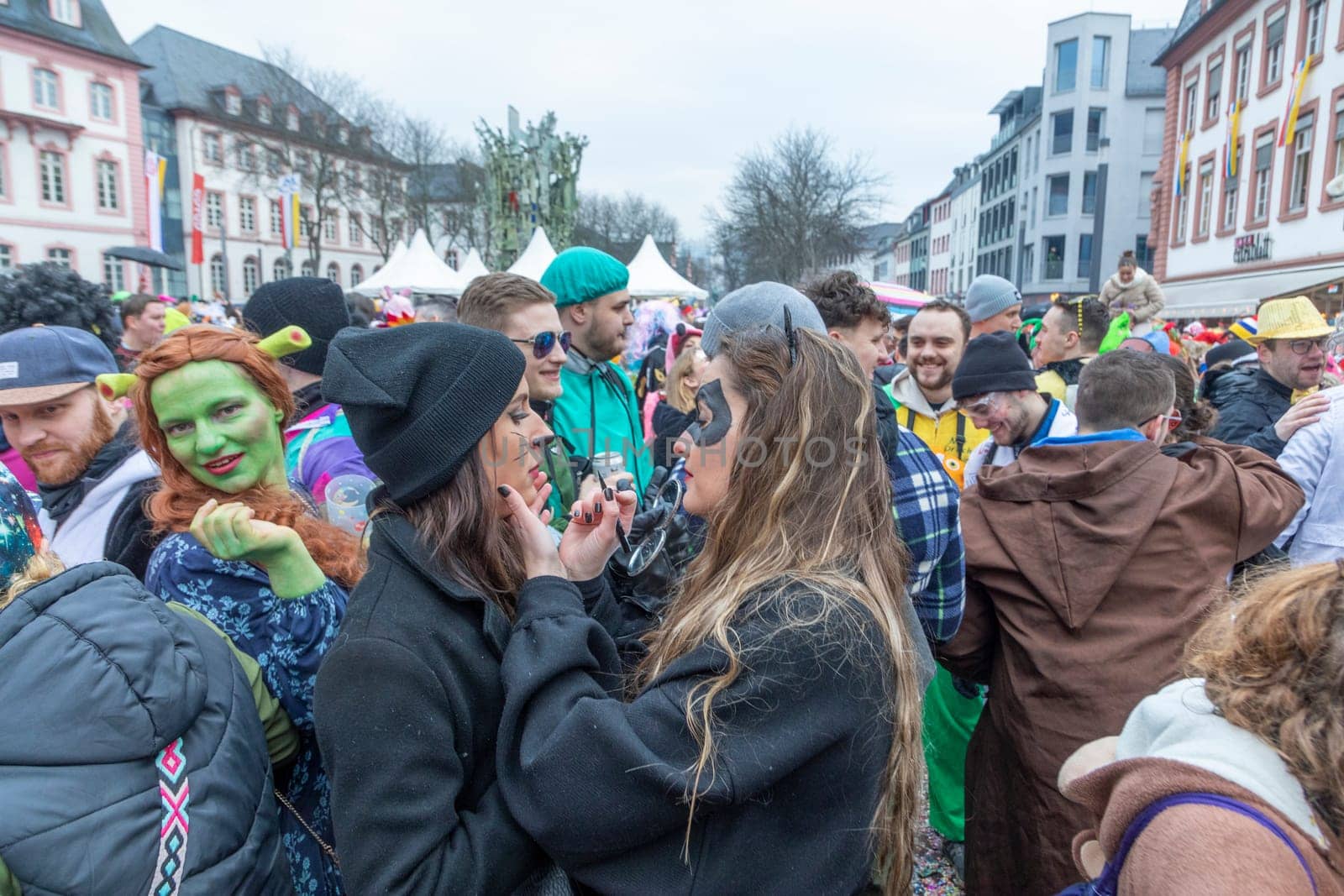 Mainz, Germany - February 16, 2023: people celebrate the Weiberfastnacht - engl womans carnival - in Mainz at the schiller square in Germany.