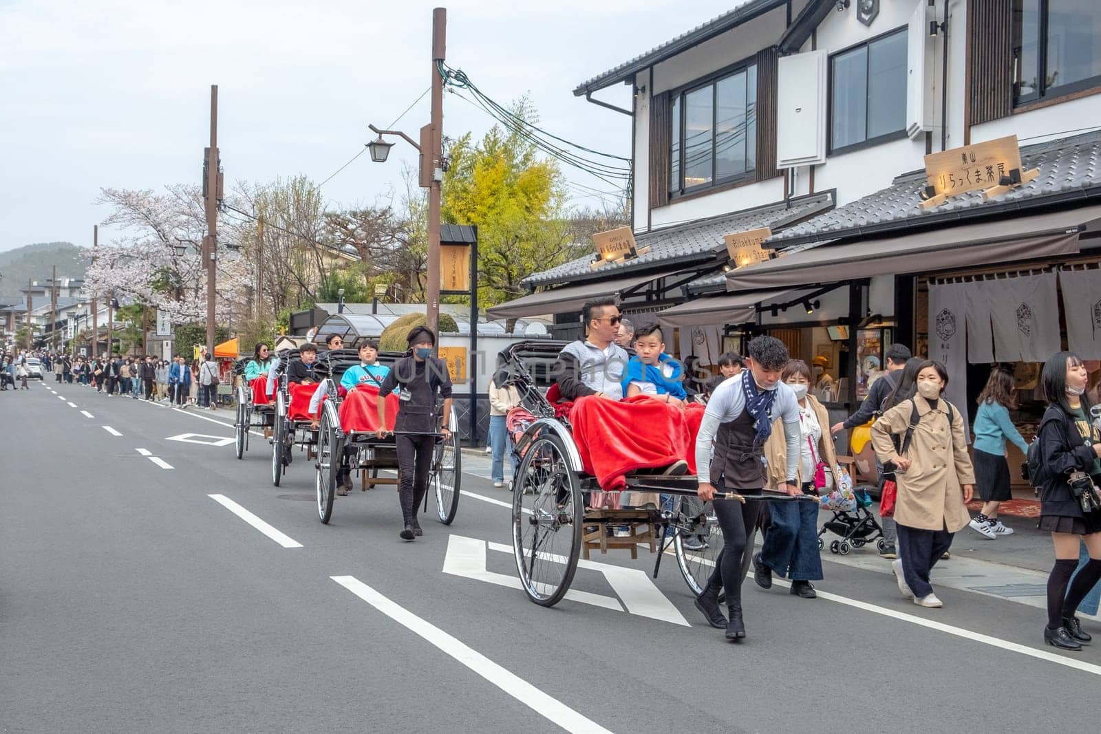 Kyoto, Japan - March 25, 2023:  japanese tourists like to go on a sightseeing trip by rickshaw in Kyoto.
