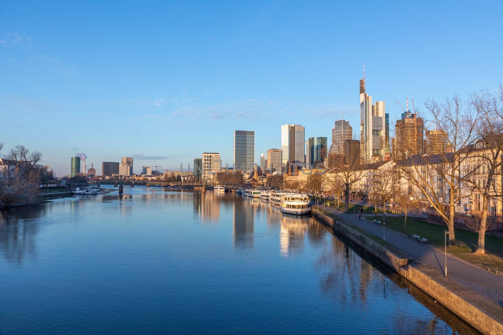 Frankfurt, Germany - February 28, 2023: scenic view to skyline of Frankfurt am Main with reflection of the skyline in river Main.
